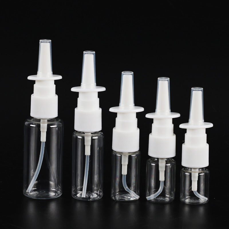 Set of five clear plastic bottles with white nozzles on a black background